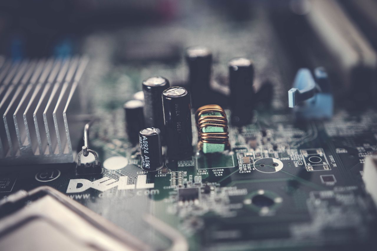 Home Detailed close-up of a motherboard showcasing electronic components and circuits.