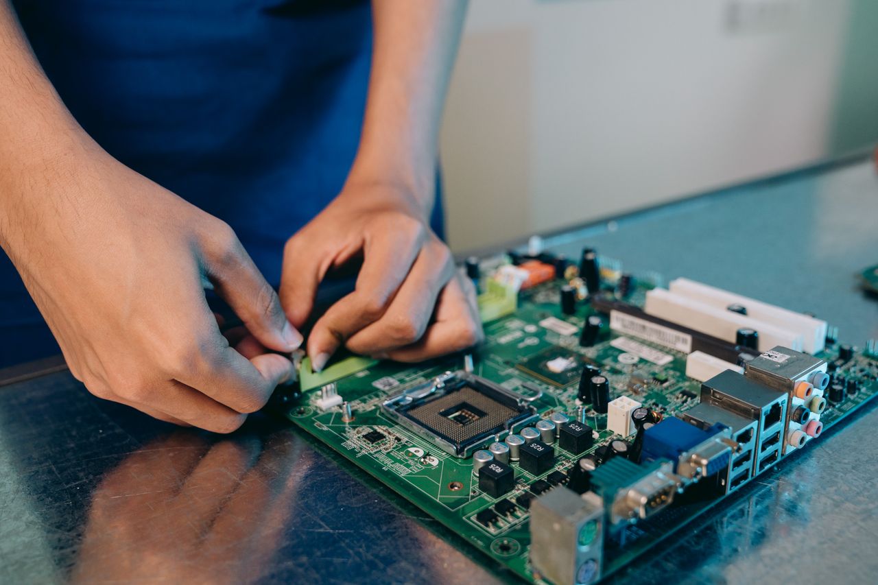 Offerings Hands-on assembly of a computer motherboard with precision tools.